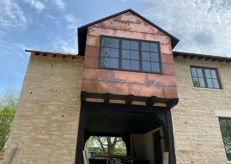 Copper metal panel facade on a stone building for Skylight Installation in Elsmere